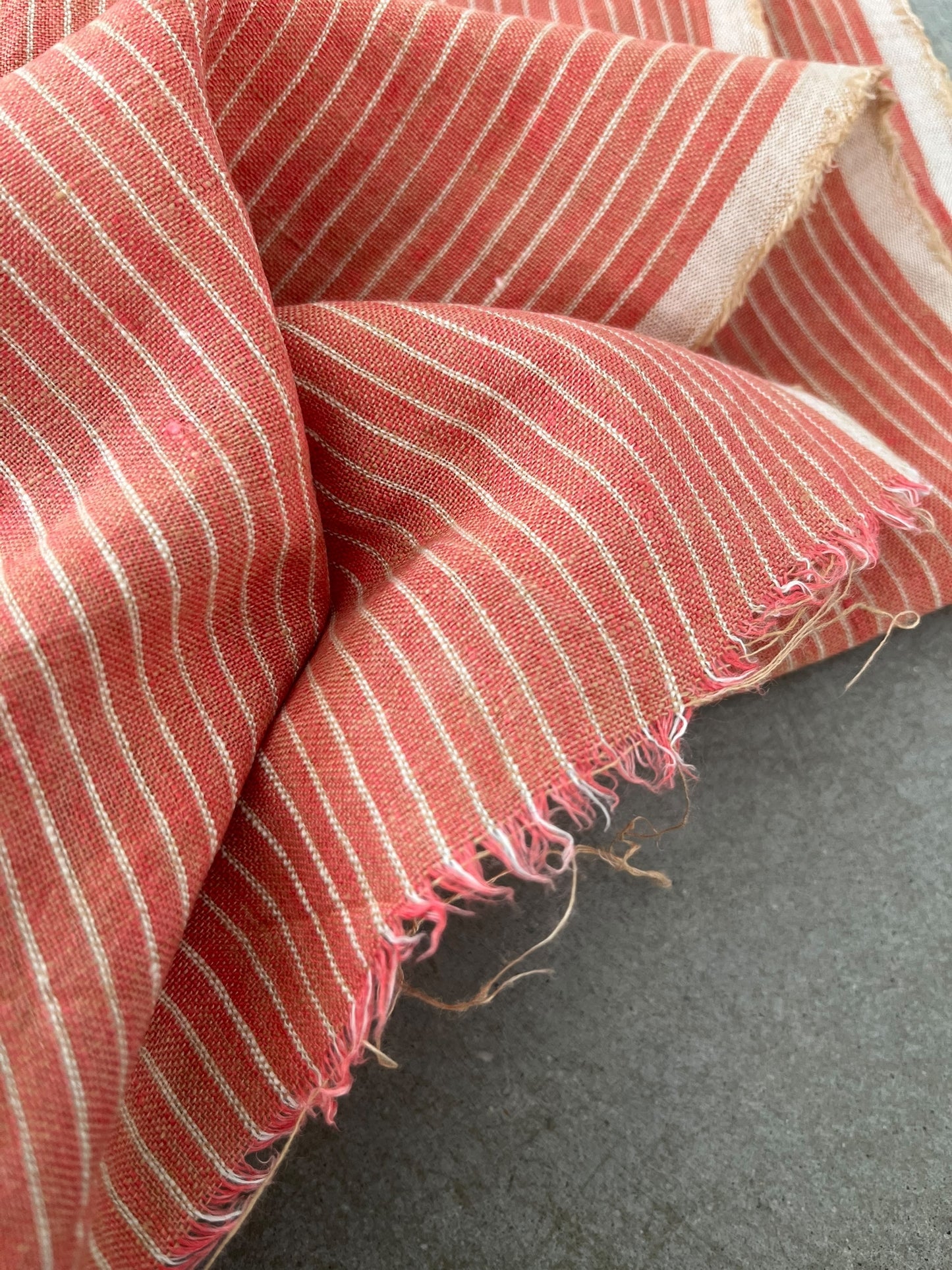 Close-up of red and white striped fabric on a dark surface
