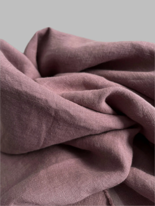 Close-up of a folded mauve fabric with a soft texture.