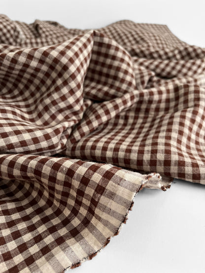 Brown gingham linen fabric on a white background 