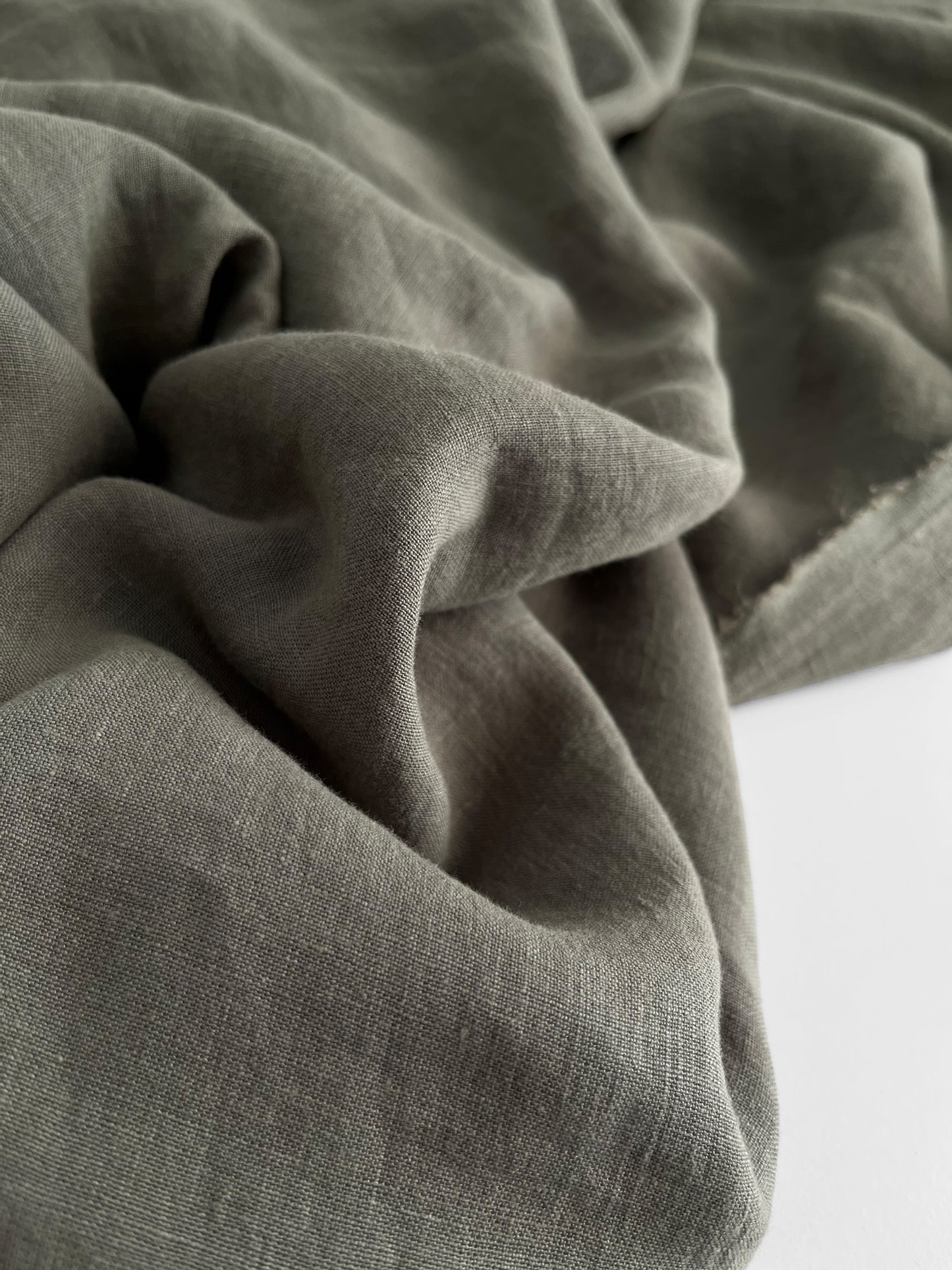 Close-up of textured green fabric on a white background
