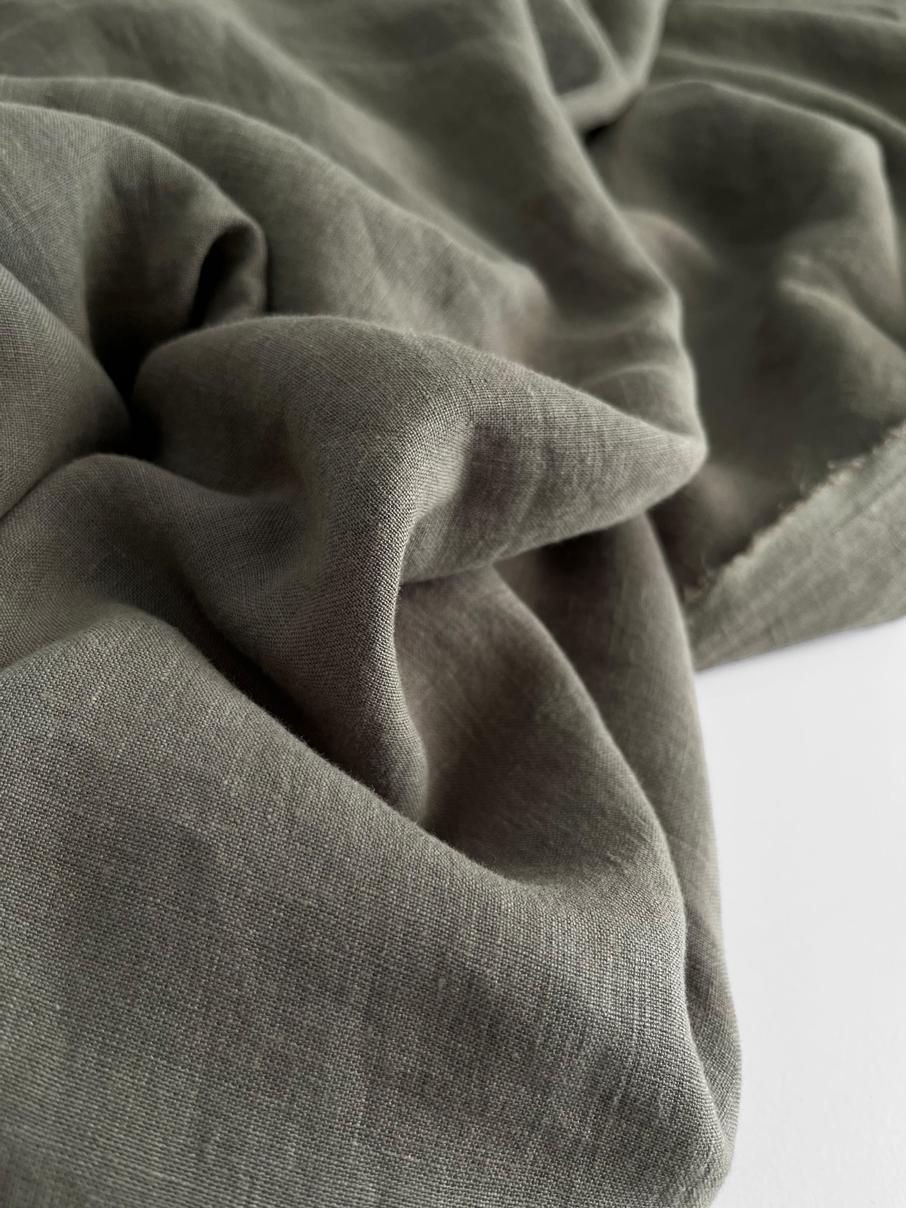 Close-up of textured green fabric on a white background