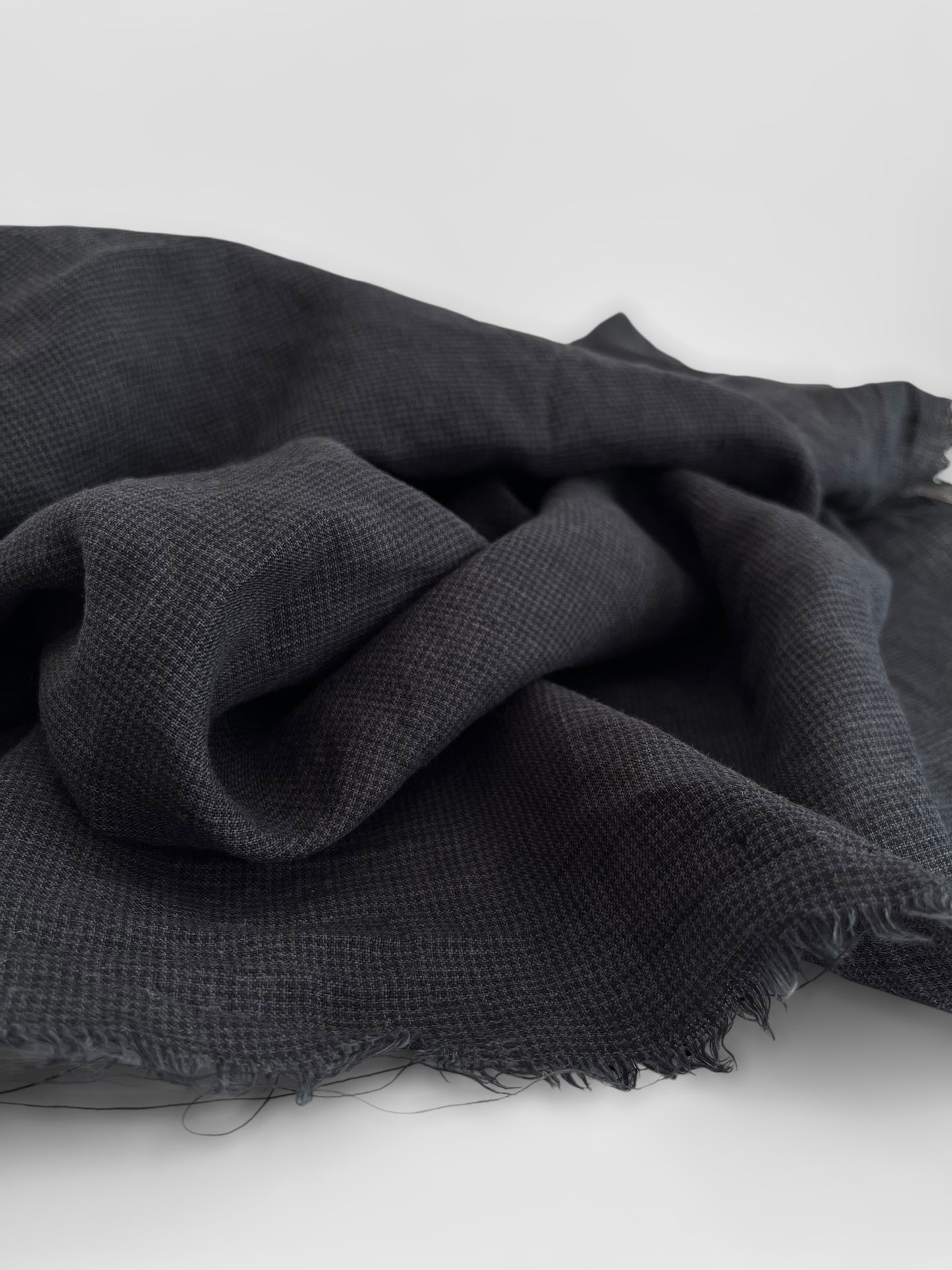 Black fabric with a textured pattern on a white background