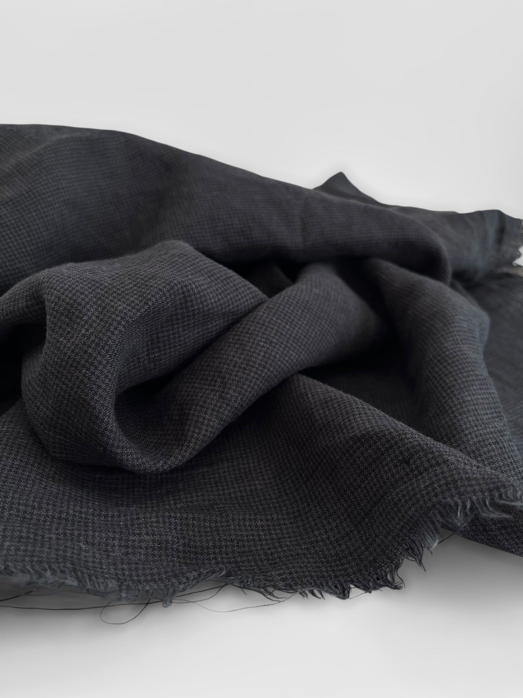 Black fabric with a textured pattern on a white background