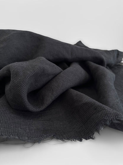 Black fabric with a textured pattern on a white background