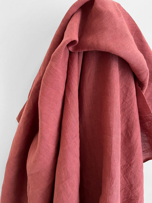 Close-up of a pinkish-red fabric draped over a white background