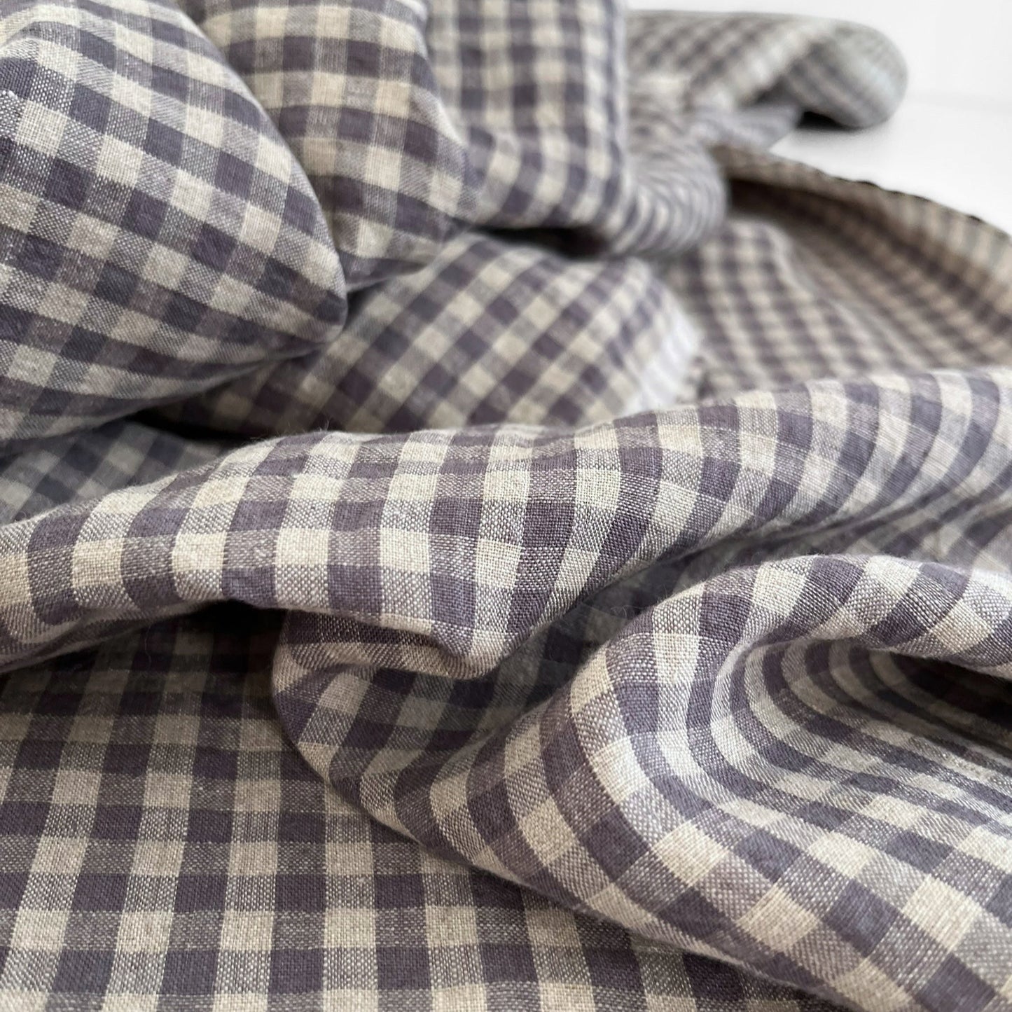 Close-up of checkered fabric with purple and beige pattern