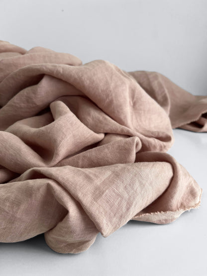 Pink fabric draped over a white surface