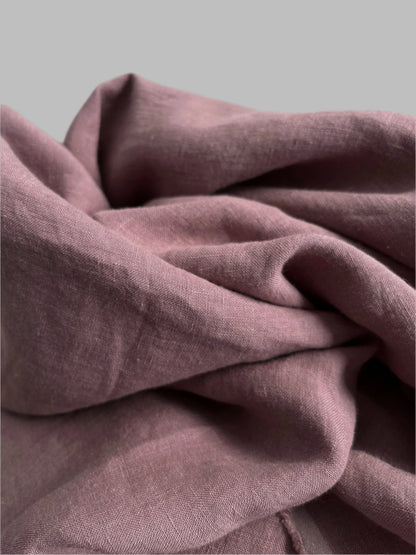 Close-up of a folded mauve fabric with a soft texture.