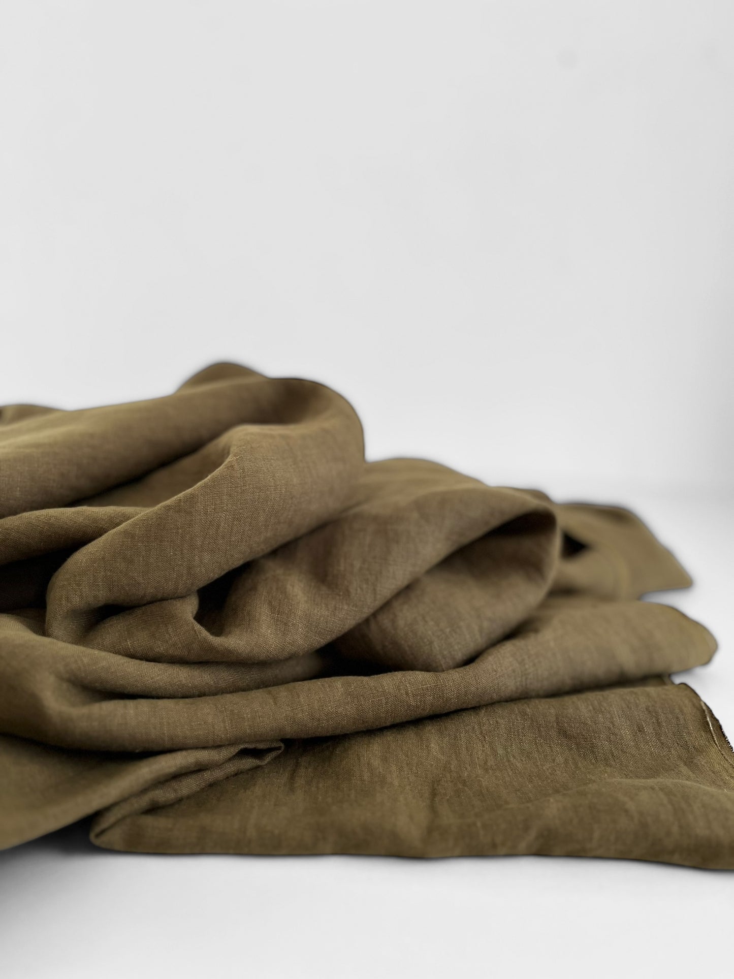 Folded khaki brown fabric on a white background