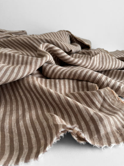 Mocha brown stripy linen fabric on a white background 